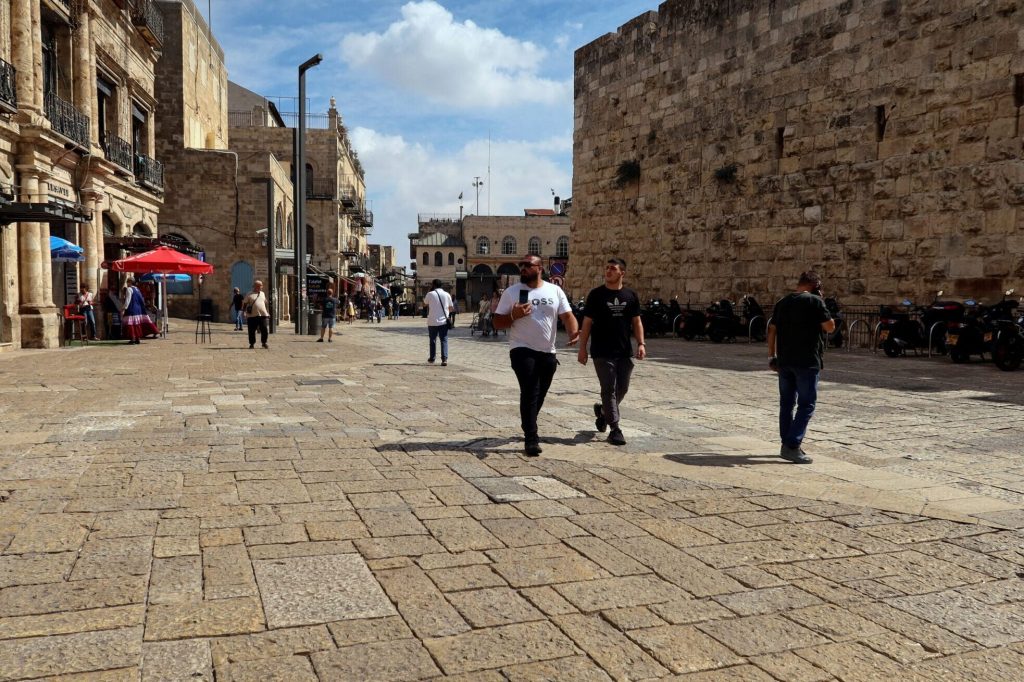 People Walk Into Jerusalems Old City Via Jaffa Gate As The Conflict Wreaks Havoc Across The Tourism Sector Scaled E1697751922172.jpeg