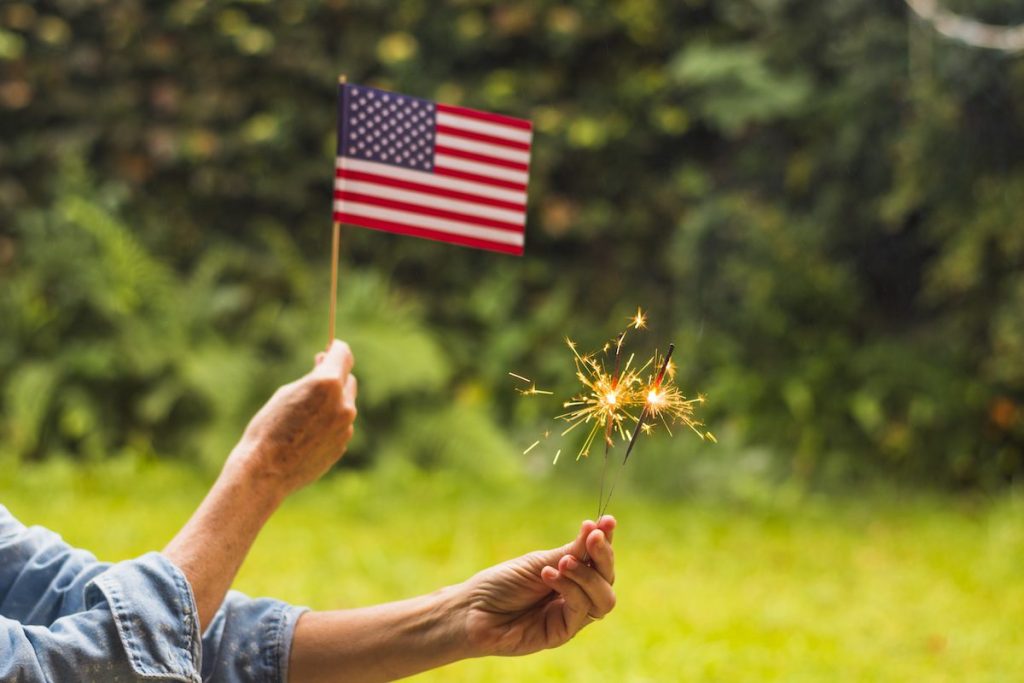 Close Up Woman Celebrating Independence Day Holding Usa Flag Fire Sparkles.jpg