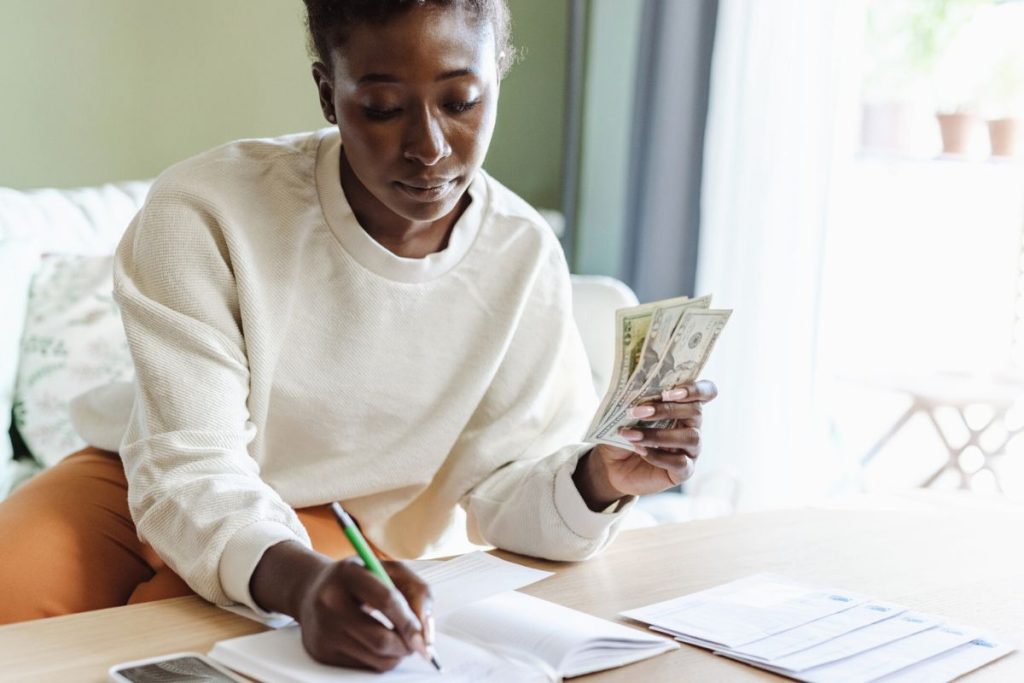 Woman Counting Money And Budgeting.jpg