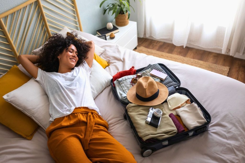 Woman Laying Next To Suitcase.jpg